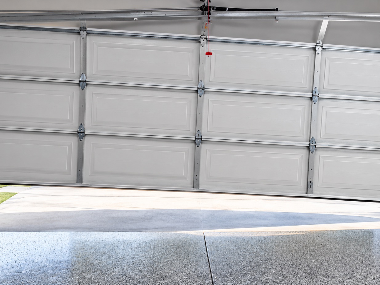 Garage door stuck crooked in the opening, off its track on one side